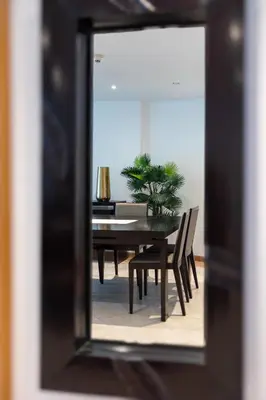 a dining room table and chairs in a mirror at Stunning 1BD Marina view apartment in Dubai Marina in Dubai