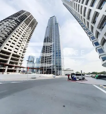 two tall buildings in a city with a street at 1 Bedroom Apartment in JLT in Dubai