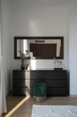 a black dresser with a mirror in a room at GMA Amwaj 2BR Sea View High Floor in Dubai