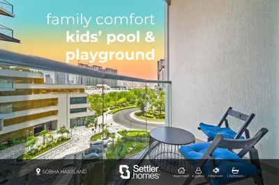 a balcony with two chairs and a table and a view at SettlerHomes - 2BR Downtown Haven, Ideal For Family Comfort in Dubai