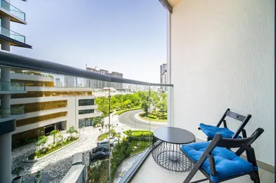 a balcony with two chairs and a table on a building at SettlerHomes - 2BR Downtown Haven, Ideal For Family Comfort in Dubai