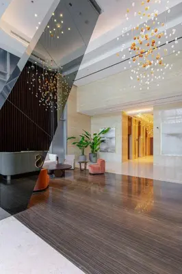 a lobby with a staircase in a building at Trendy Studio! Walk to Burj Khalifasleeps 3! in Dubai