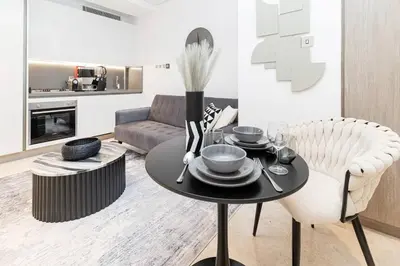 a living room with a table and a couch at Trendy Studio! Walk to Burj Khalifasleeps 3! in Dubai