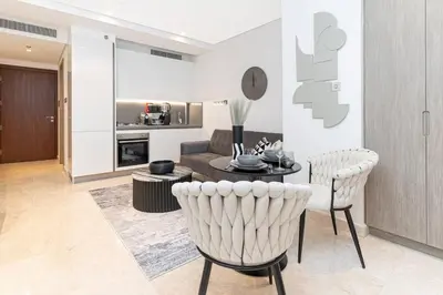 a living room with a couch and a table and chairs at Trendy Studio! Walk to Burj Khalifasleeps 3! in Dubai