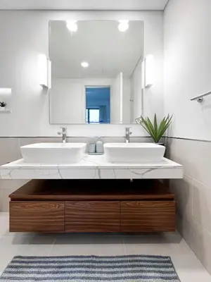 a bathroom with two sinks and a large mirror at Spectacular 2BR Apartment Full BurjAlArab View in Dubai