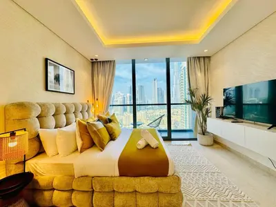 a large bedroom with a large bed with a large window at Chic Studio with Burj Views at Sterling by Omniyat in Dubai