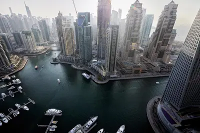 a view of a large city with boats in the water at BRAND NEW LUXURY 1 BR Apartment at Marina Gate 2 full Marina view in Dubai