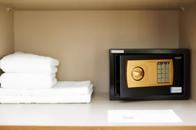 a microwave in a room with a stack of towels at BRAND NEW LUXURY 1 BR Apartment at Marina Gate 2 full Marina view in Dubai