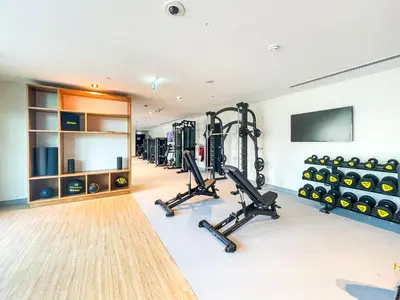 a gym with a row of treadmills and weights at Amazing Apartment with City Views in Downtown 164BC-2 in Dubai