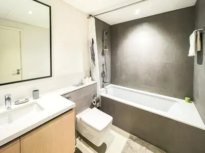 a bathroom with a sink and a toilet and a bath tub at Amazing Apartment with City Views in Downtown 164BC-2 in Dubai