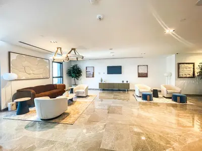 a large living room with a couch and chairs at Amazing Apartment with City Views in Downtown 164BC-2 in Dubai