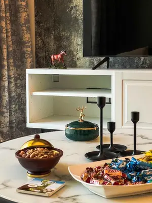 a table with a plate of food and a bowl of nuts at Cozy Apartment with City Views Next to Burj Khalifa 166FO1-2 in Dubai
