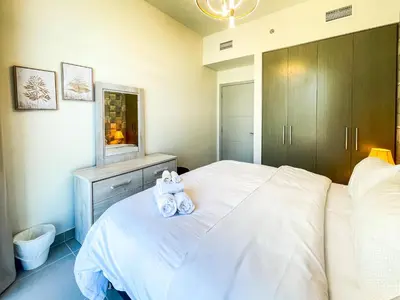 two stuffed animals sitting on a bed in a bedroom at Cozy Apartment with City Views Next to Burj Khalifa 166FO1-2 in Dubai