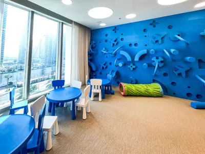 a classroom with blue walls and tables and chairs at Cozy Apartment with City Views Next to Burj Khalifa 166FO1-2 in Dubai
