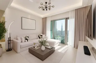 a living room with a white couch and a table at Daniels 2BR at Downtown with Burj Khalifa View in Dubai