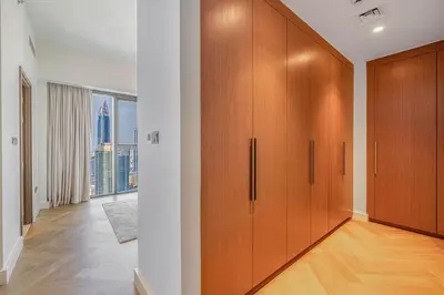 a hallway with wooden cabinets in a apartment at Daniels 3BR Urban Retreat with Downtown Views in Dubai