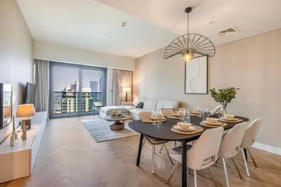a living room with a table and a couch at Daniels 3BR Urban Retreat with Downtown Views in Dubai