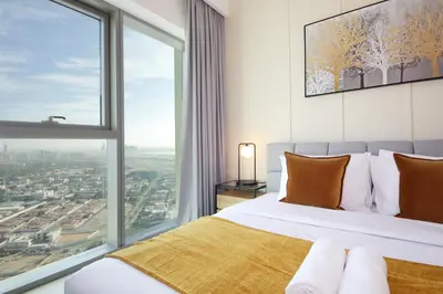 a bedroom with a bed and a large window at RH- Live in Luxury, 01BR with spectacular view in Dubai