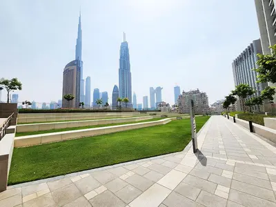 a park in the middle of a city with tall buildings at RH- Live in Luxury, 01BR with spectacular view in Dubai