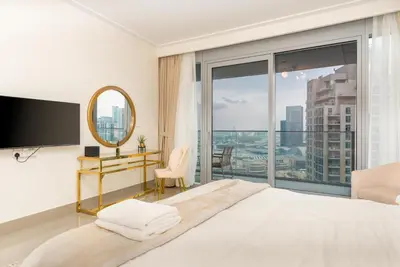 a bedroom with a large bed and a large window at WhiteSage - Opera Grand Elegance 3BR with Burj Khalifa Views in Dubai