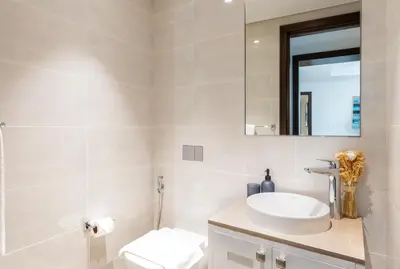a bathroom with a sink and a mirror at WhiteSage - Opera Grand Elegance 3BR with Burj Khalifa Views in Dubai
