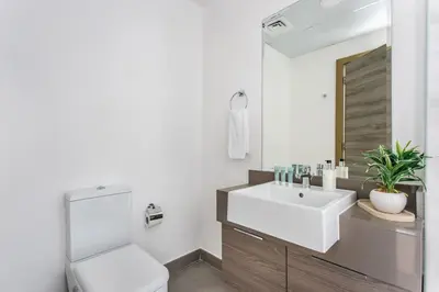 a bathroom with a white toilet and a sink at Frank Porter - Bloom Tower C in Dubai