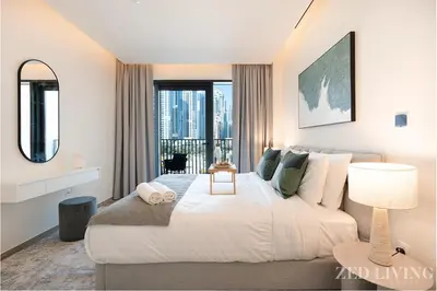 a bedroom with a large bed with a large window at Ahad Residences - City Retreat Apartments - Zed Living in Dubai