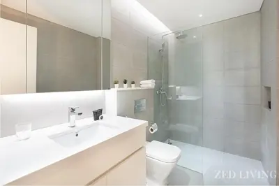 a bathroom with a sink and a toilet and a shower at Ahad Residences - City Retreat Apartments - Zed Living in Dubai