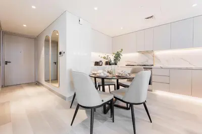 a kitchen and dining room with a table and chairs at Stayis -Luxurious 2BR Apartment with breathtaking ocean and Marina View in Dubai