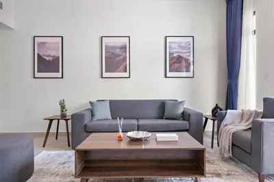 a living room with a couch and a coffee table at StoneTree - Furnished 1BR in Madinat Jumeirah in Dubai