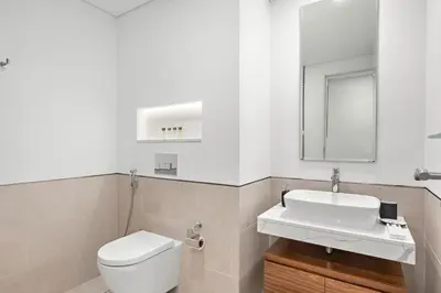 a bathroom with a white toilet and a sink at StoneTree - Furnished 1BR in Madinat Jumeirah in Dubai