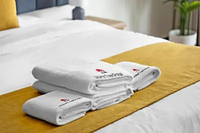 a pile of towels sitting on top of a bed at Luxury 1BR - Leisure Facilities Access - Sea View in Dubai