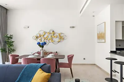 a dining room with a table and chairs at Luxury 1BR - Leisure Facilities Access - Sea View in Dubai
