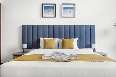 a bed with two towels on top of it at Luxury 1BR - Leisure Facilities Access - Sea View in Dubai