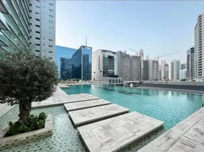 a large swimming pool in the middle of a city at Luxury Hotel Apartment - DownTown in Dubai