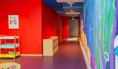 a room with red walls and a hallway with a room with a unintention at Luxury Hotel Apartment - DownTown in Dubai