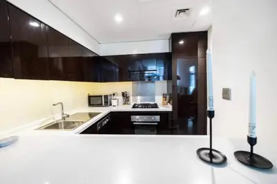a kitchen with a sink and a stove at Luxury Hotel Apartment - DownTown in Dubai