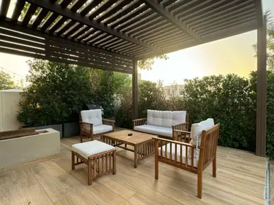 a patio with chairs and a couch and a table at Oraya - Brand New Luxurious 3BR plus 2M Villa in Maple 2 in Dubai