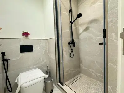 a bathroom with a shower and a toilet in it at Oraya - Brand New Luxurious 3BR plus 2M Villa in Maple 2 in Dubai