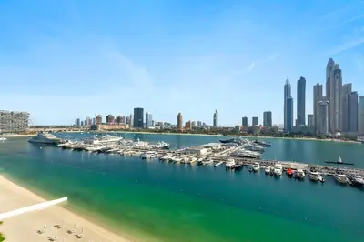 a marina with boats in the water and a city at Luxurious Living in the heart of Emaar Beachfront in Dubai