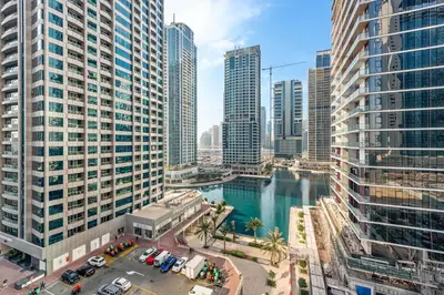 an aerial view of a city with tall buildings at StoneTree - Furnished 1BR in JLT with Lake View in Dubai
