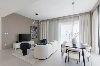 a white living room with a table and chairs at Creek Beach Roomy 3BR + terrace in Dubai