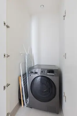 a washing machine sitting in a room next to a door at Creek Beach Roomy 3BR + terrace in Dubai