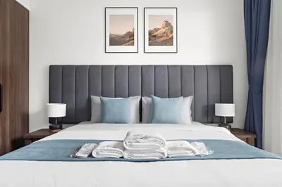 a bedroom with a bed with two towels on it at StoneTree - Luxury 1BR - Best Location for Tourist in Dubai
