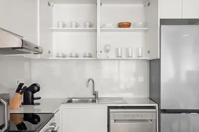 a kitchen with white cabinets and a sink at StoneTree - Luxury 1BR - Best Location for Tourist in Dubai