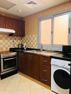 a kitchen with a sink and a dishwasher at Home Away From Home - Barsha Heights in Dubai