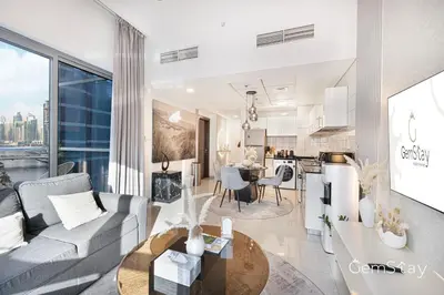 a living room with a couch and a table at Your Cosy Marina Retreat in Dubai