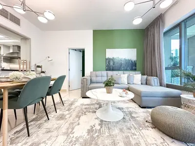 a living room with a couch and a table at Trophy - 29 Boulevard Tower Downtown Suite in Dubai