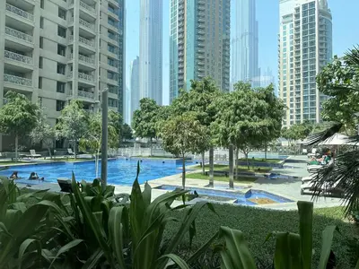 a pool in the middle of a city with tall buildings at Trophy - 29 Boulevard Tower Downtown Suite in Dubai
