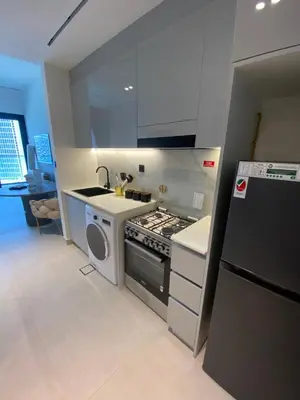 a small kitchen with a stove and a sink at White and gold studio apartment in Binghatti Canal whit pool in Dubai